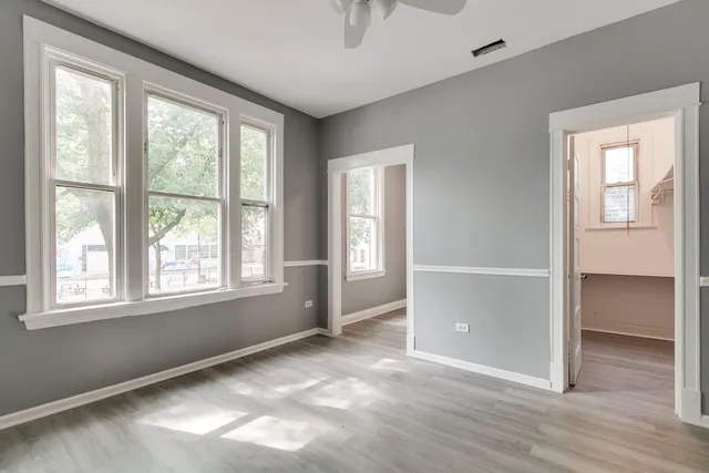 an empty room with windows and closet