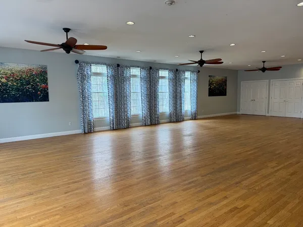 a view of a livingroom with a ceiling fan and window