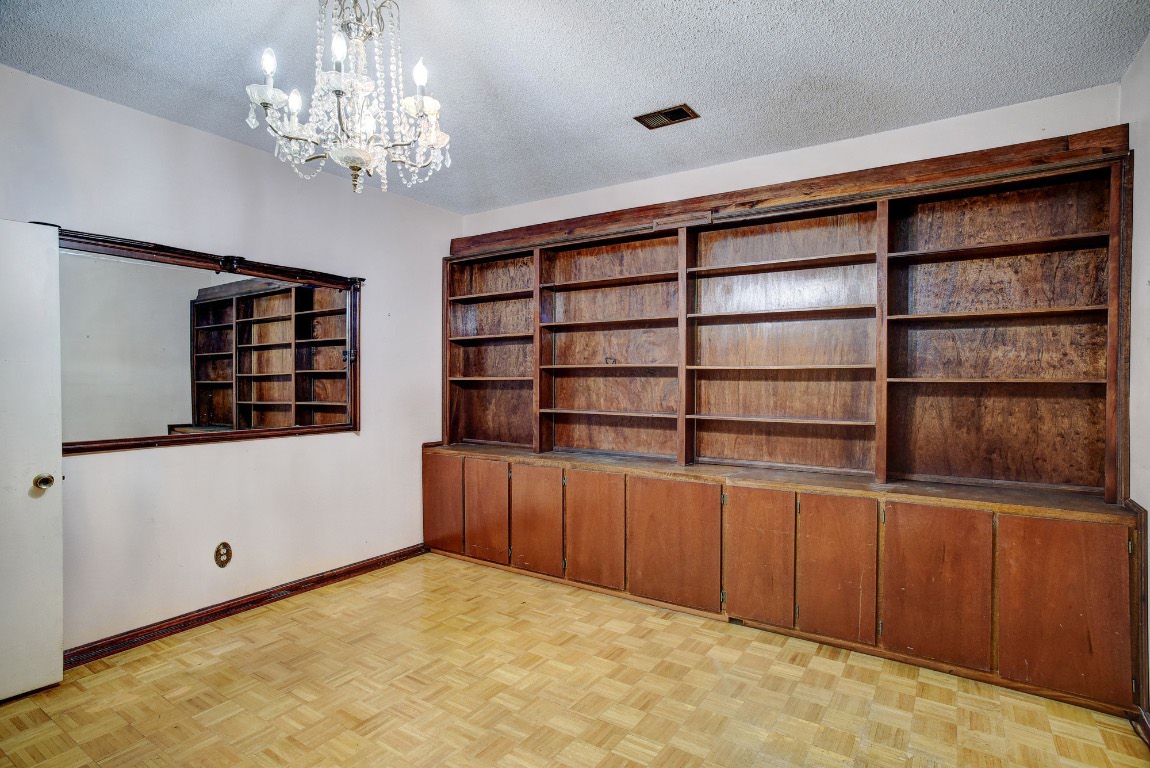 113 My Road Bastrop, TX 78602 - Photo 20 of 35 Unfurnished dining area with a textured ceiling and a chandelier