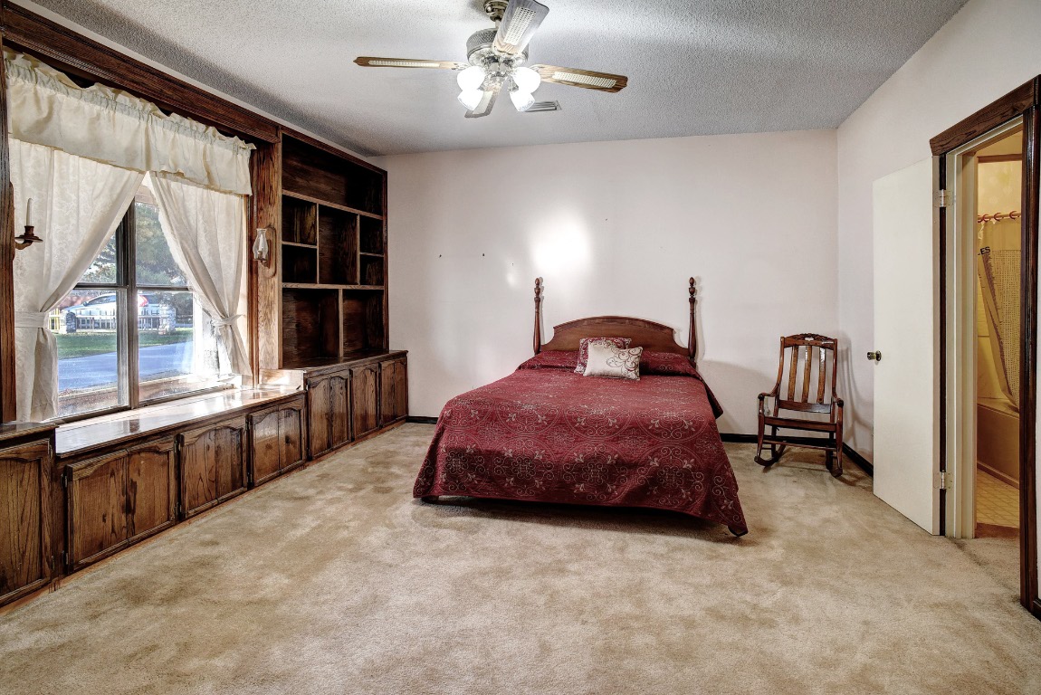 113 My Road Bastrop, TX 78602 - Photo 25 of 35 Bedroom featuring a textured ceiling, light carpet, and ceiling fan