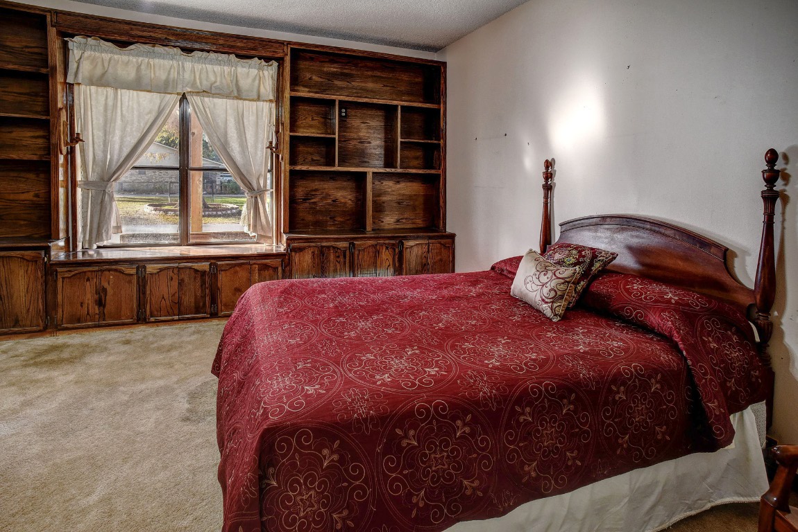 113 My Road Bastrop, TX 78602 - Photo 26 of 35 Bedroom with light carpet and a textured ceiling