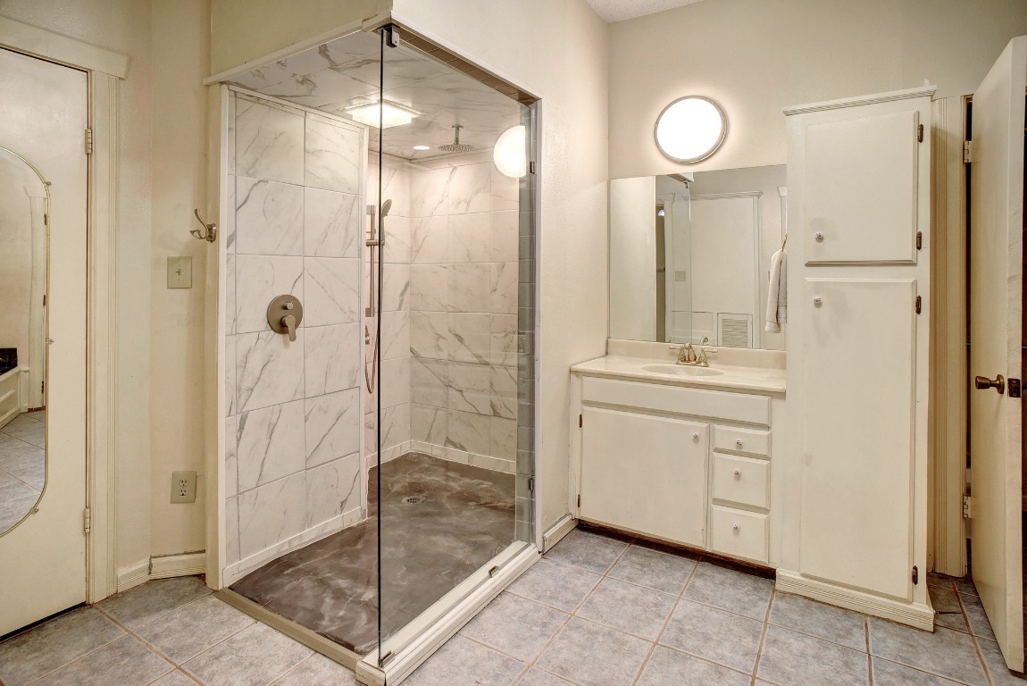 113 My Road Bastrop, TX 78602 - Photo 27 of 35 Bathroom featuring vanity, a marble finish shower, and light tile patterned floors