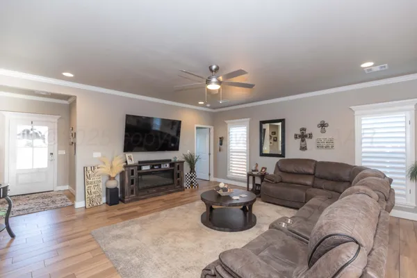 a kitchen with stainless steel appliances granite countertop a sink a stove and a wooden floors