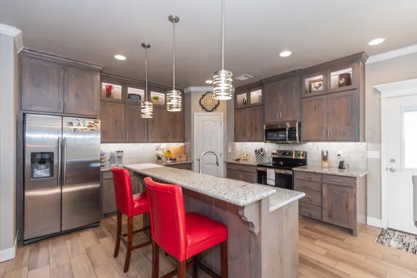 a bedroom with a large bed and a chandelier