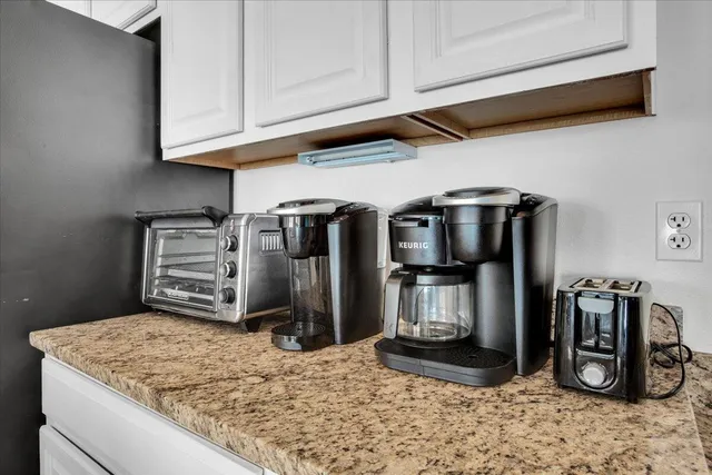 a bedroom with a large bed and a painting on the wall