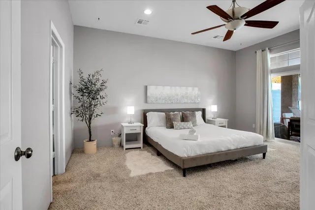 a bedroom with a bed and a window