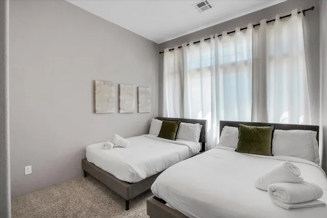 a living room with furniture a rug and a large window