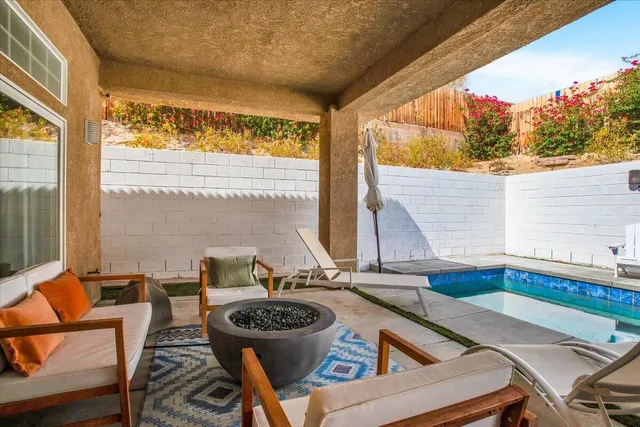 a view of a house with swimming pool and sitting area
