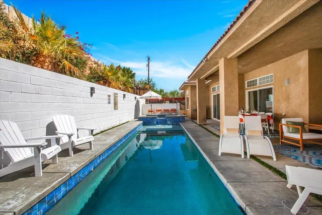 a view of swimming pool with outdoor seating