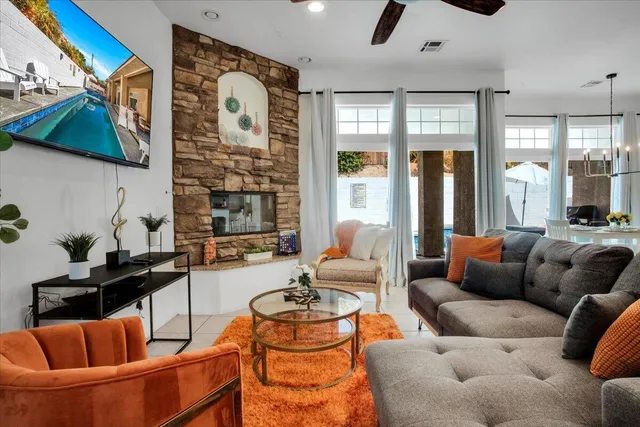 a kitchen with kitchen island granite countertop a stove sink and refrigerator