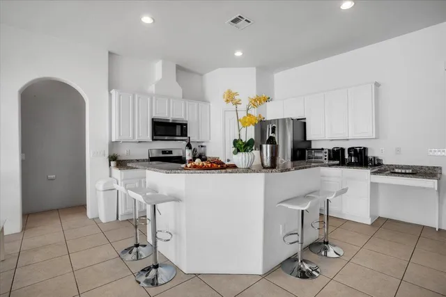 a view of a dining room with furniture wooden floor and a chandelier