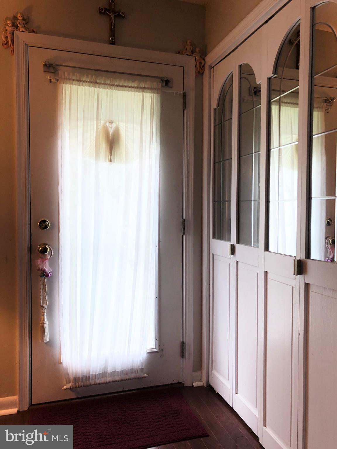 Front door with closet.