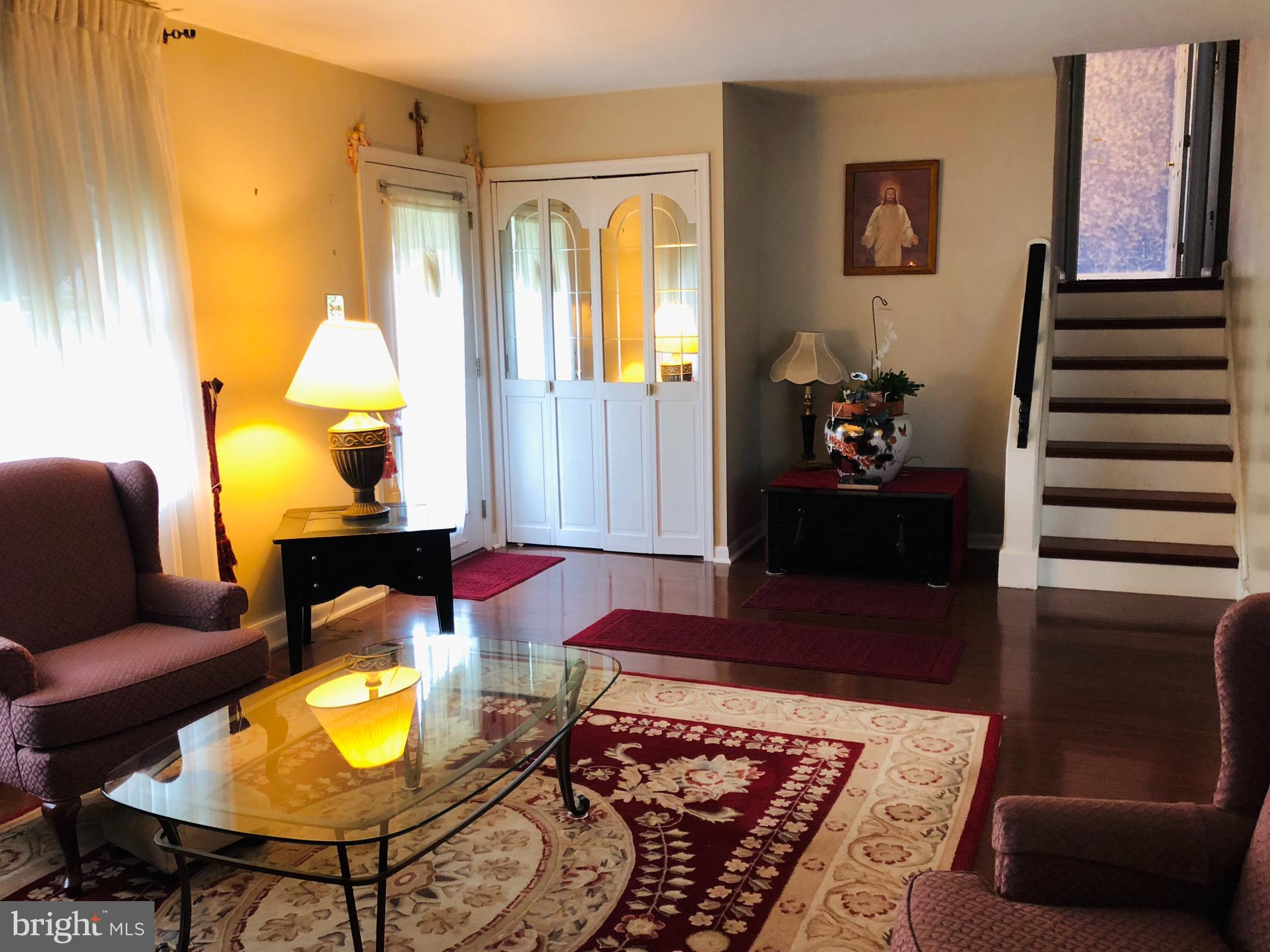 Living room with stairway to the second floor.