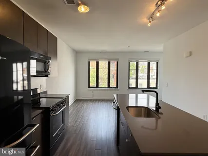 a kitchen with granite countertop a stove and a sink