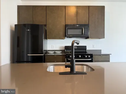a kitchen with a refrigerator and a stove