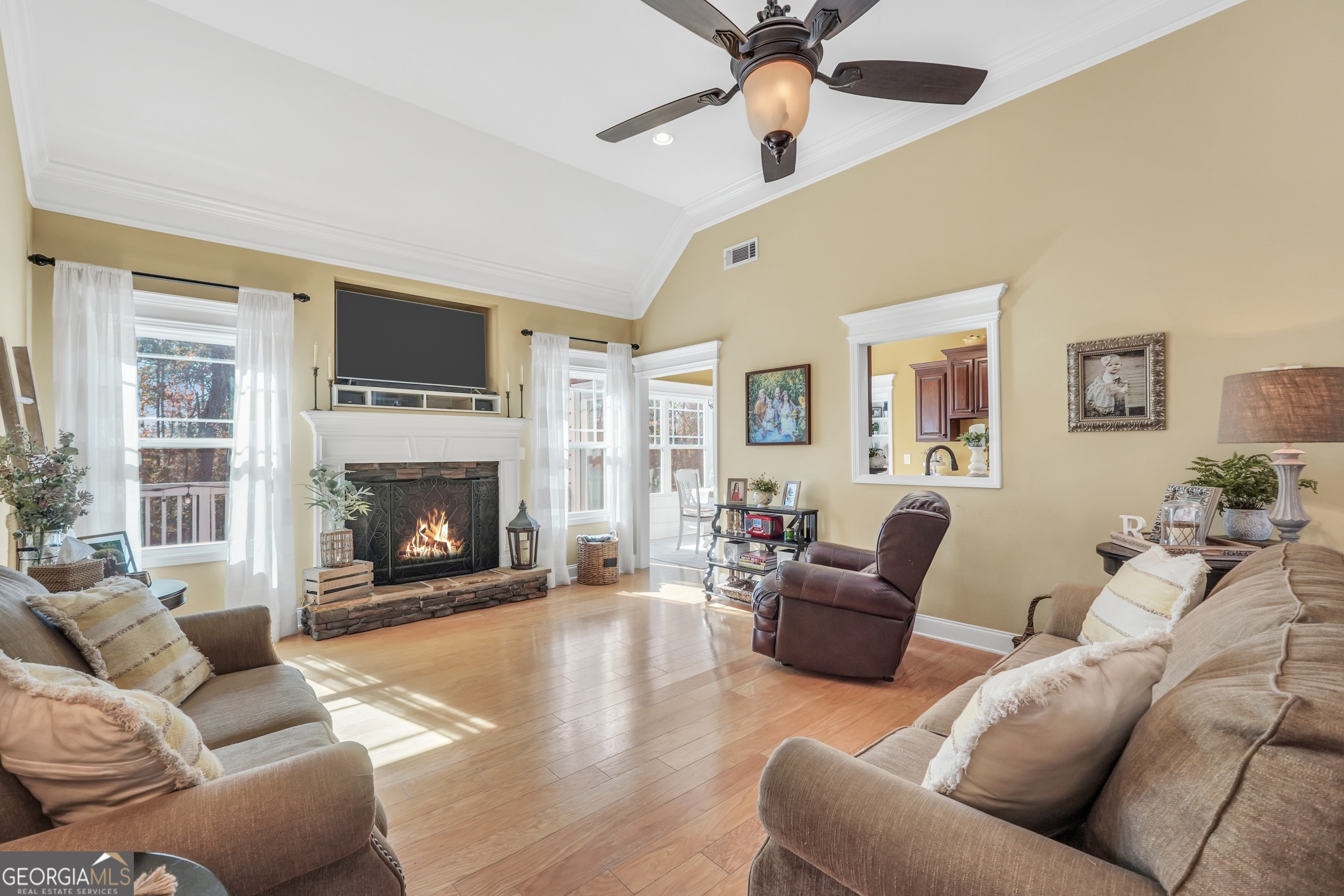 196 Magnolia Trace Milner, GA 30257 - Photo 14 of 48 a living room with furniture a flat screen tv and a fireplace