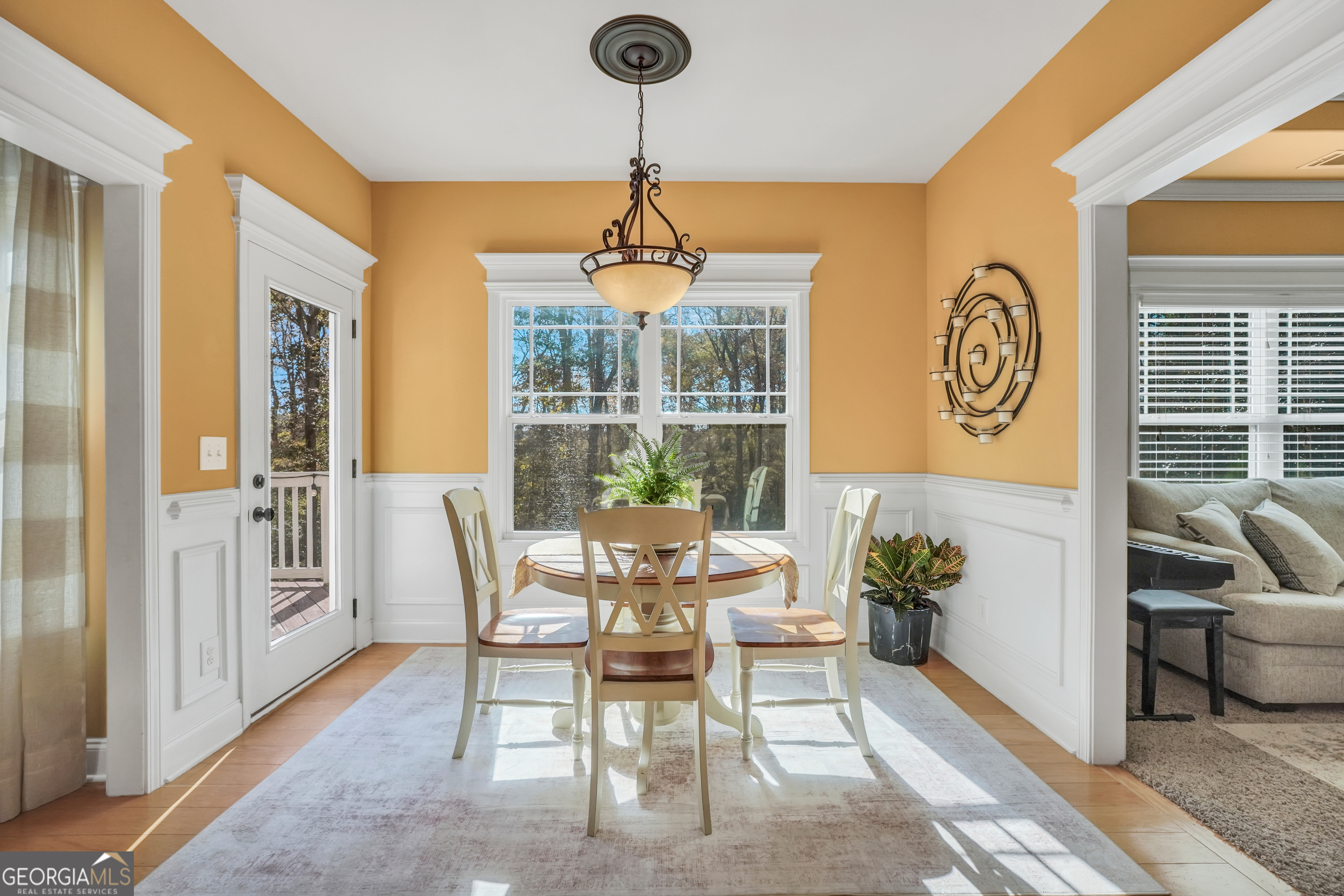 196 Magnolia Trace Milner, GA 30257 - Photo 23 of 48 a dining room with furniture a chandelier and wooden floor