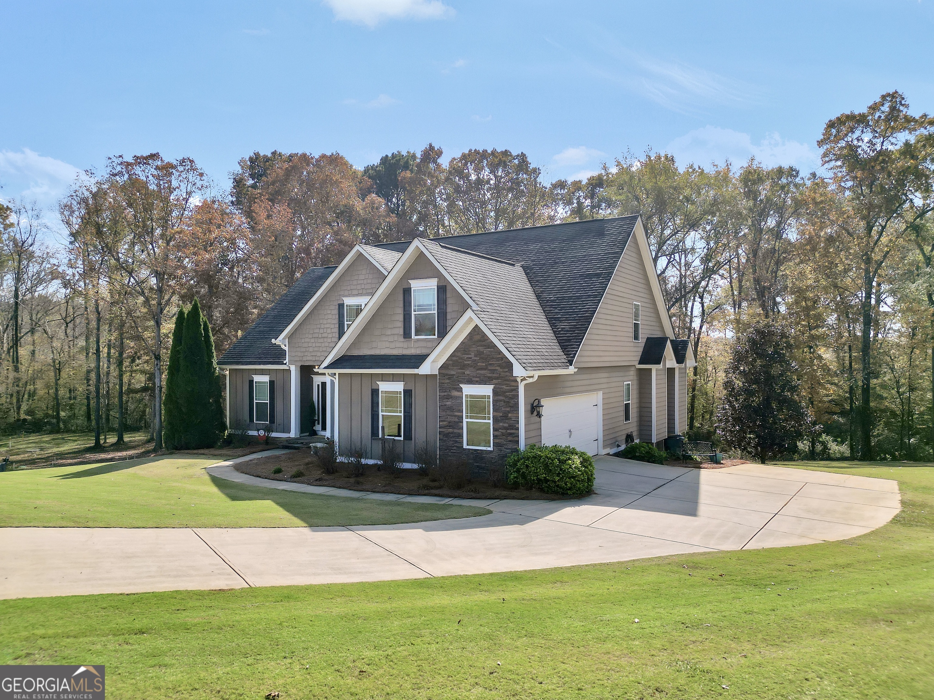 196 Magnolia Trace Milner, GA 30257 - Photo 4 of 48 a front view of a house with a garden and trees