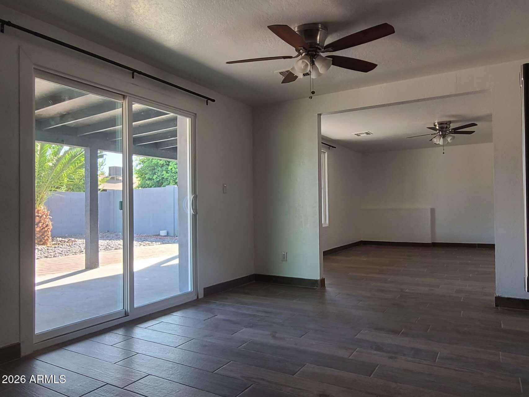 3702 East Thunderbird Road Phoenix, AZ 85032 - Photo 6 of 23 a view of empty room with wooden floor and fan