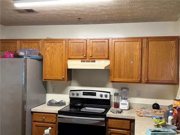 a kitchen with a stove and a refrigerator