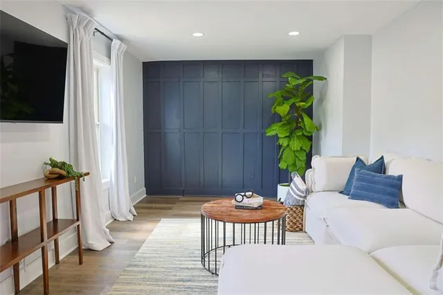 a balcony with furniture and wooden floor