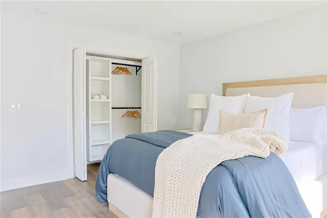 a bedroom with a bed and a mirror