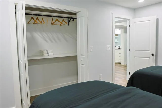 a bedroom with a bed and a mirror