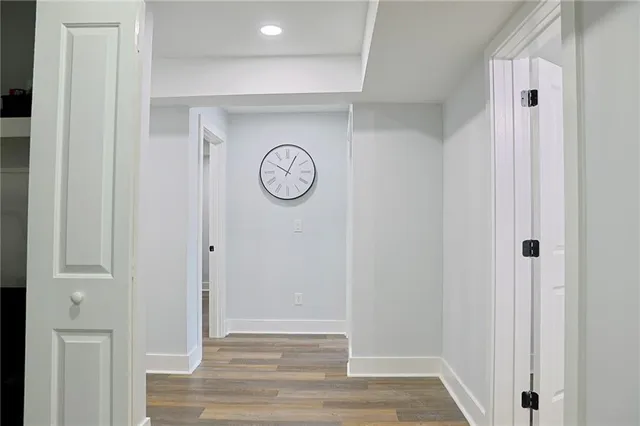 a view of a hallway with wooden floor