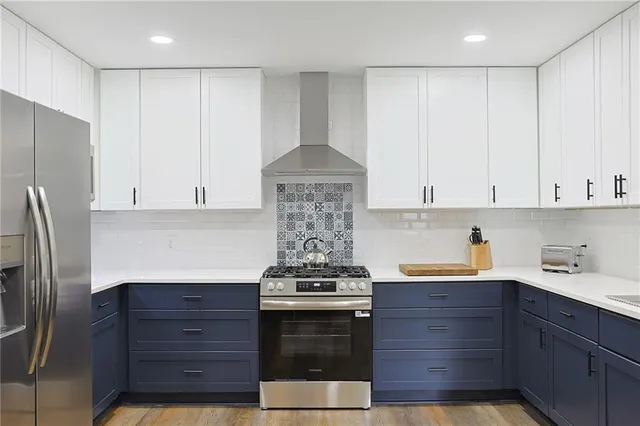 a kitchen with stainless steel appliances granite countertop a stove and a refrigerator
