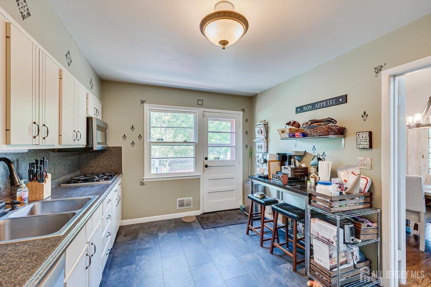 12 Gales Road Edison, NJ 08837 - Photo 15 of 35 a kitchen that has a lot of cabinets a sink and appliances in it