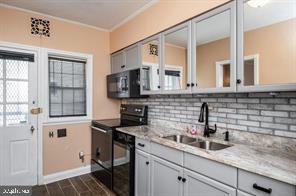 1618 Roundhill Road Baltimore, MD 21218 - Photo 14 of 50 a kitchen with a sink and cabinets