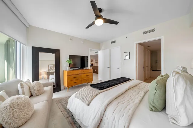 a bedroom with a large bed and a window