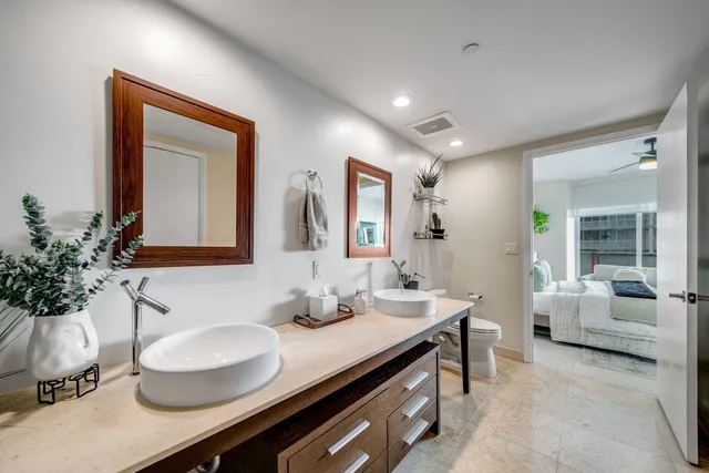a bathroom with a granite countertop sink mirror and vanity