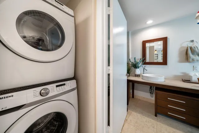 a utility room with sink dryer and washer