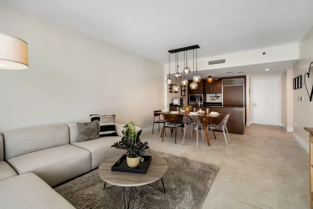 a living room with furniture and a chandelier