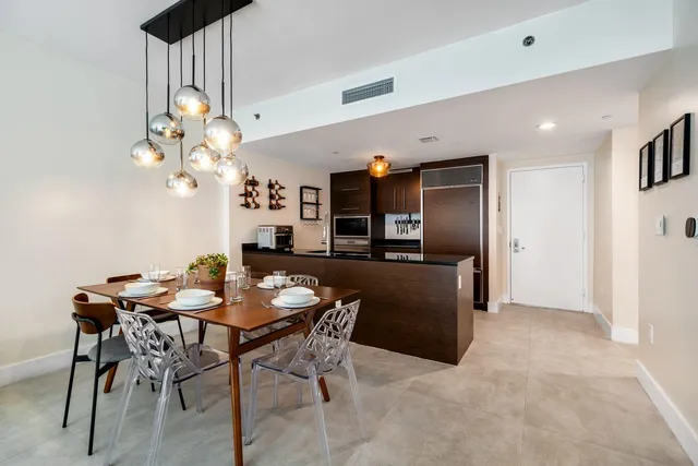 a view of a dining room with furniture and chandelier