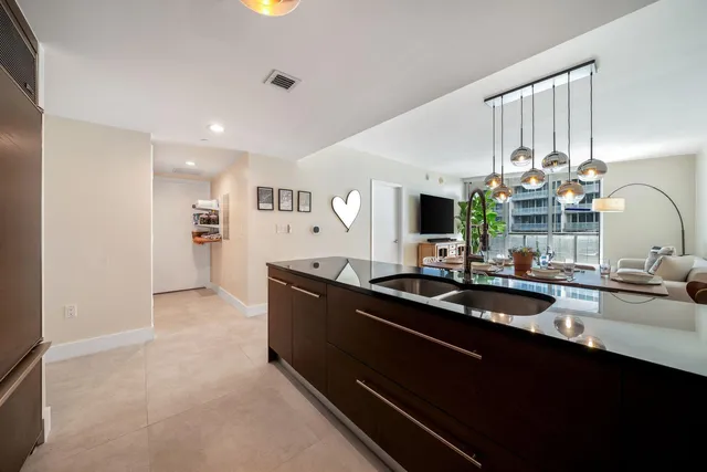 a kitchen with sink refrigerator and microwave