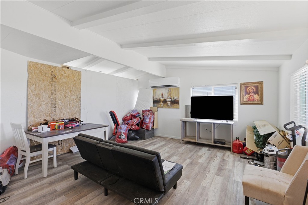5885 Dos Palmas Road Phelan, CA 92371 - Photo 5 of 40 a living room with furniture and a flat screen tv