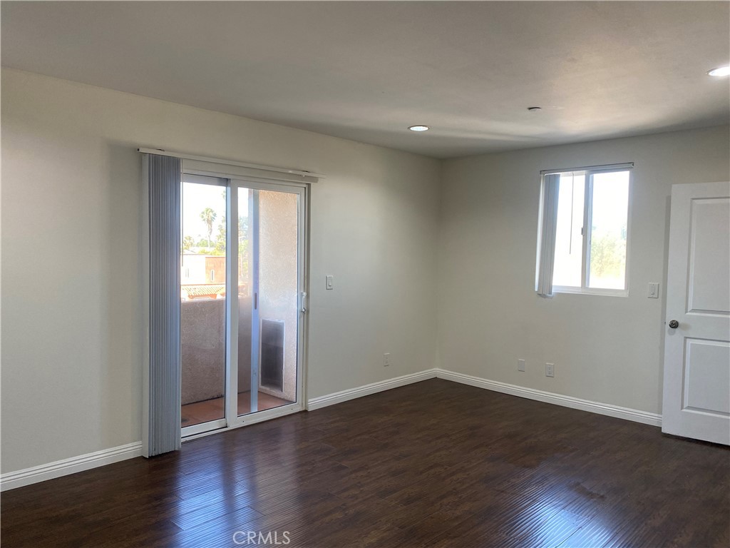 14343 Tiara Street, Unit 2 Sherman Oaks, CA 91401 - Photo 11 of 23 a view of an empty room with wooden floor and a window