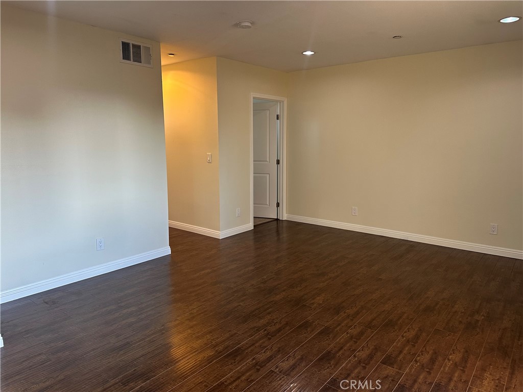 14343 Tiara Street, Unit 2 Sherman Oaks, CA 91401 - Photo 16 of 23 a view of an empty room with wooden floor and a window