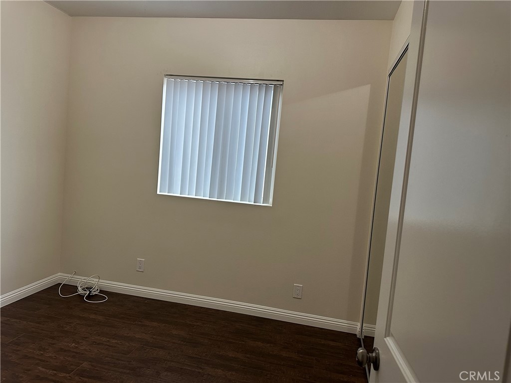 14343 Tiara Street, Unit 2 Sherman Oaks, CA 91401 - Photo 20 of 23 a view of an empty room with wooden floor and a window