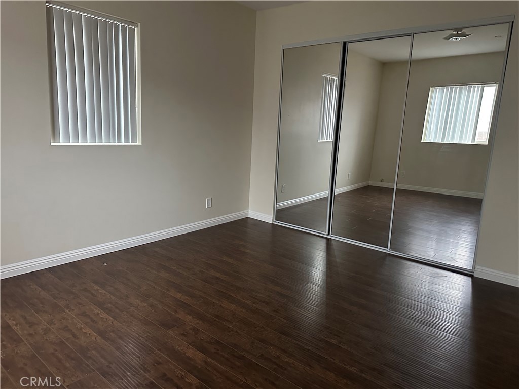 14343 Tiara Street, Unit 2 Sherman Oaks, CA 91401 - Photo 23 of 23 an empty room with wooden floor and windows