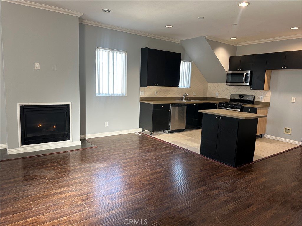 14343 Tiara Street, Unit 2 Sherman Oaks, CA 91401 - Photo 5 of 23 a kitchen with stainless steel appliances granite countertop a stove top oven and sink