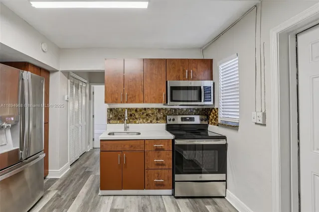 a kitchen with a sink stove and refrigerator