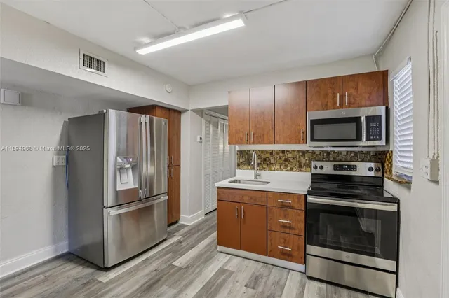 a kitchen with a refrigerator stove and microwave