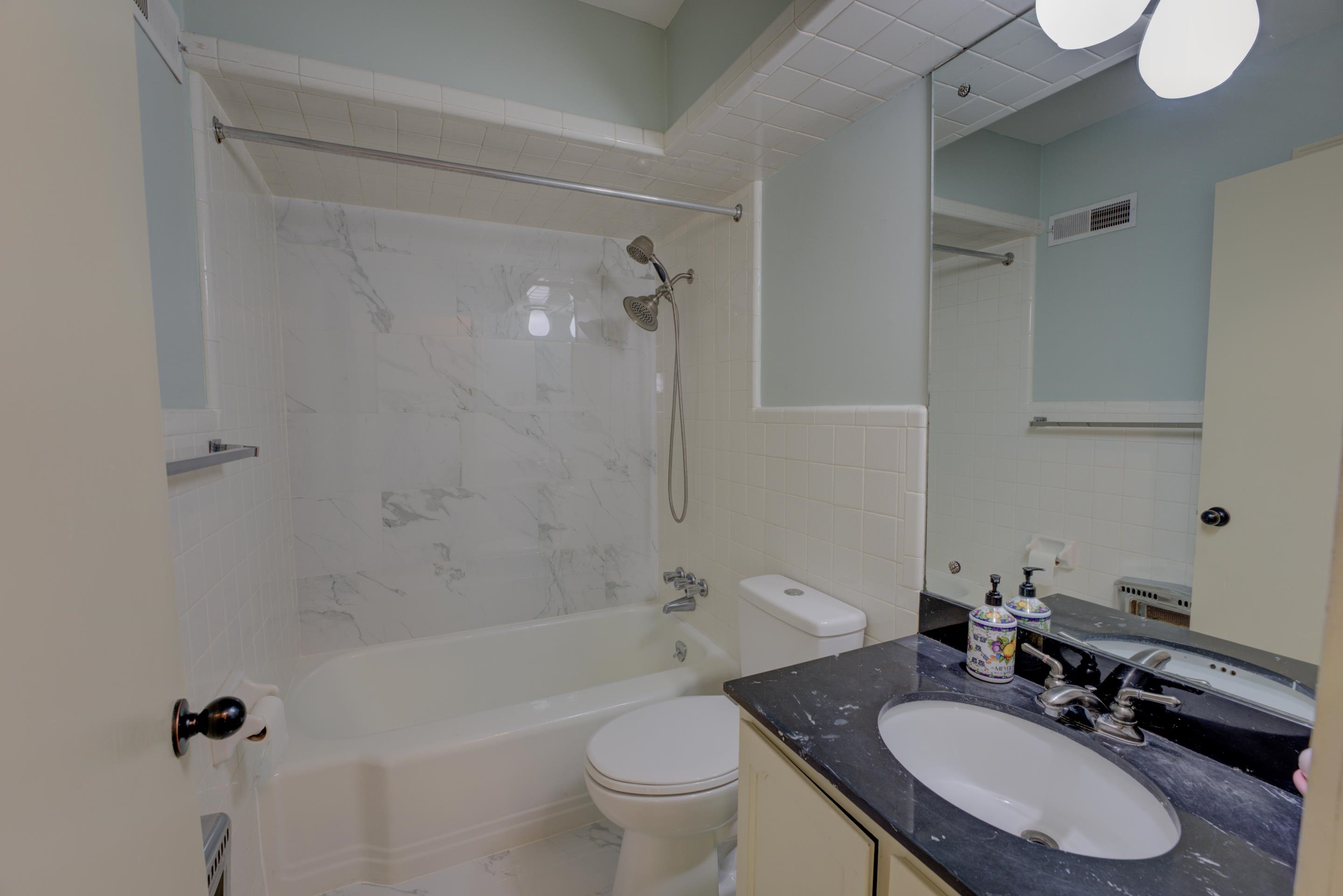 1155 Marcia Road Memphis, TN 38117 - Photo 18 of 31 a bathroom with a sink toilet a mirror and shower