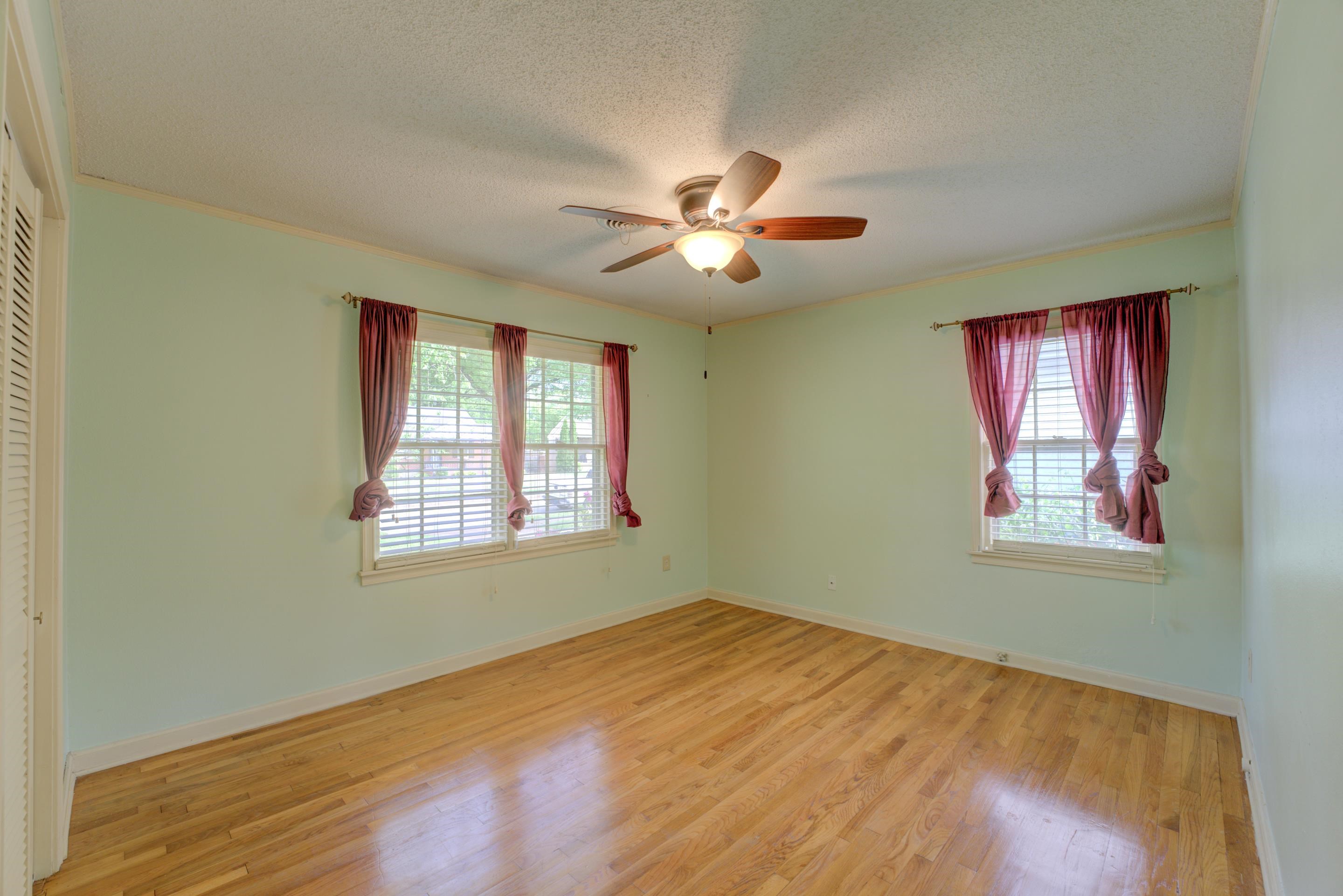 1155 Marcia Road Memphis, TN 38117 - Photo 21 of 31 a view of empty room with wooden floor and fan