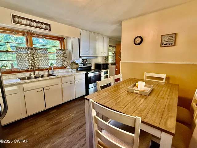a kitchen with a sink appliances and cabinets