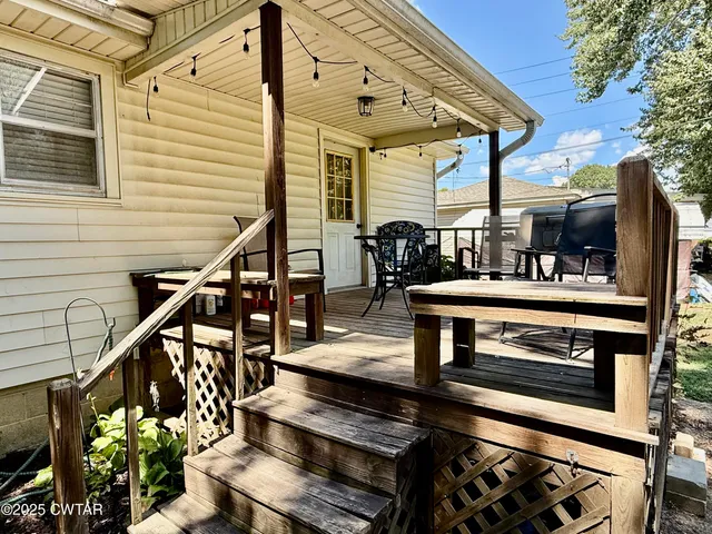a view of a chairs and table in the balcony