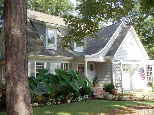 3517 Blue Ridge Road Raleigh, NC 27612 - Photo 1 of 16 a view of a house with a yard